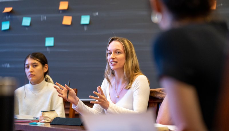 Female students discuss in a seminar setting