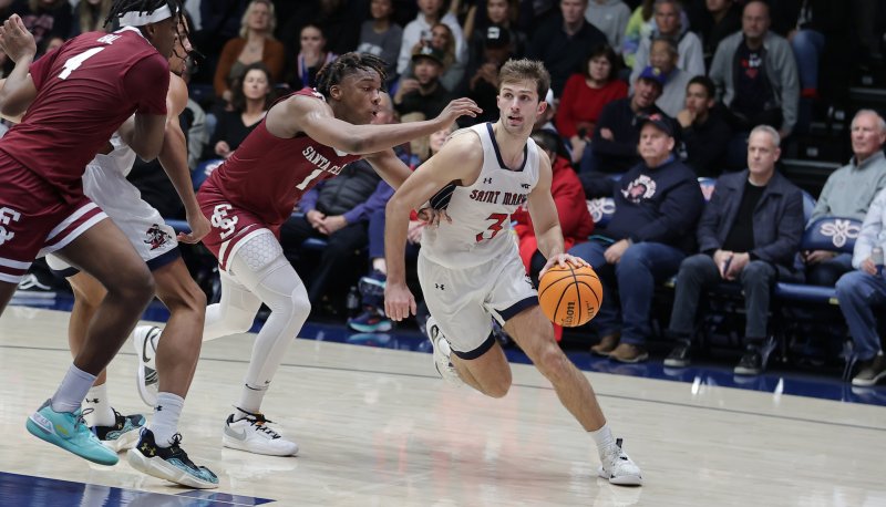 Men's basketball player Augustas Marciulionis drives against Santa Clara in January 2024