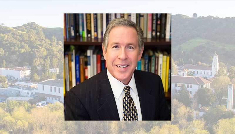 SEBA Dean Gibson with a screened image of the SMC Campus behind him