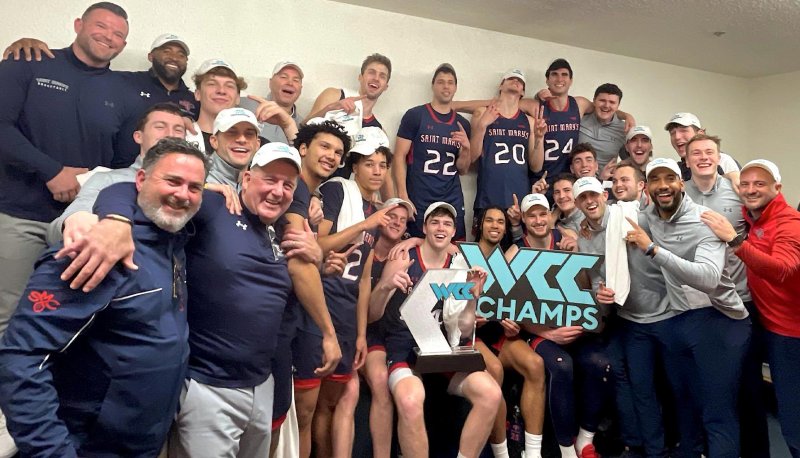 Men's Basketball team holds WCC logo to celebrate in Malibu in February 2024