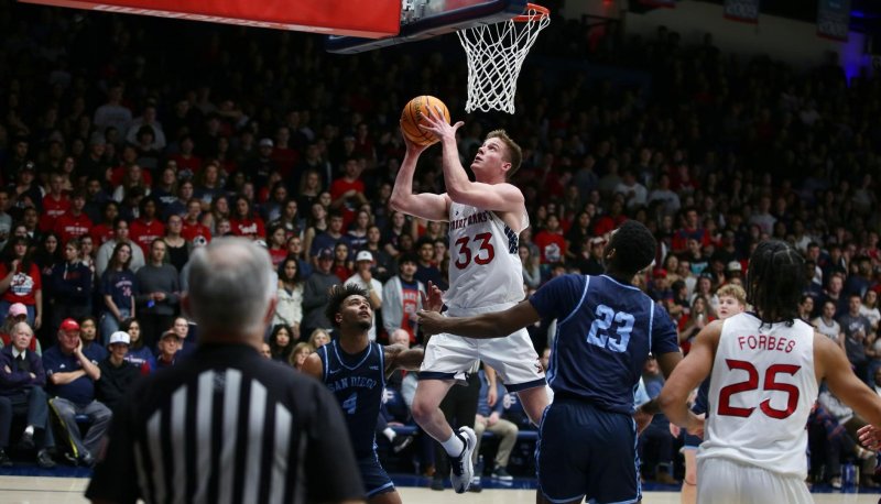 Men's Basketball player Luke Barrett shoots against San Diego in February 2024