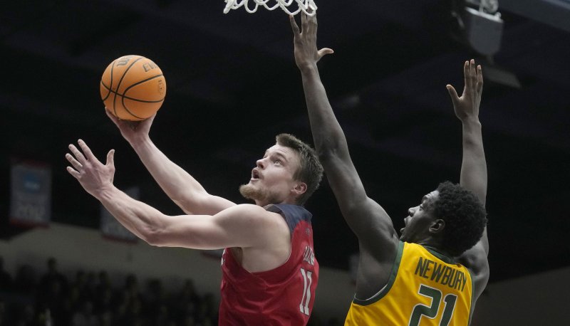 Men's basketball player Mitchell Saxen shoots against USF in February 2024