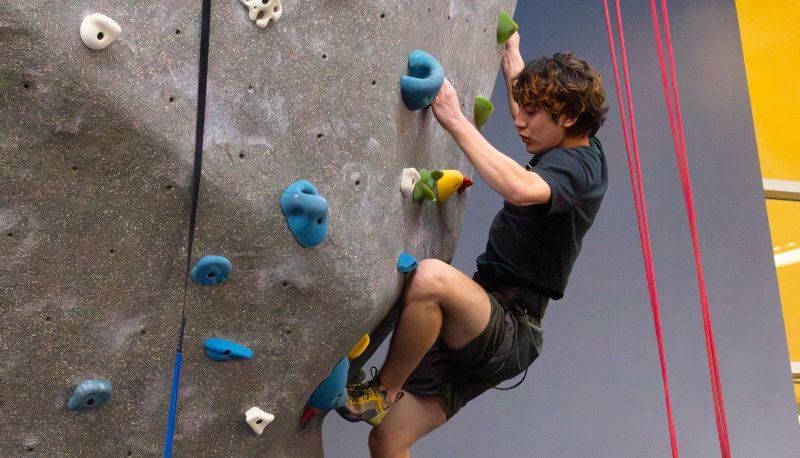 Student trying out the climbing wall