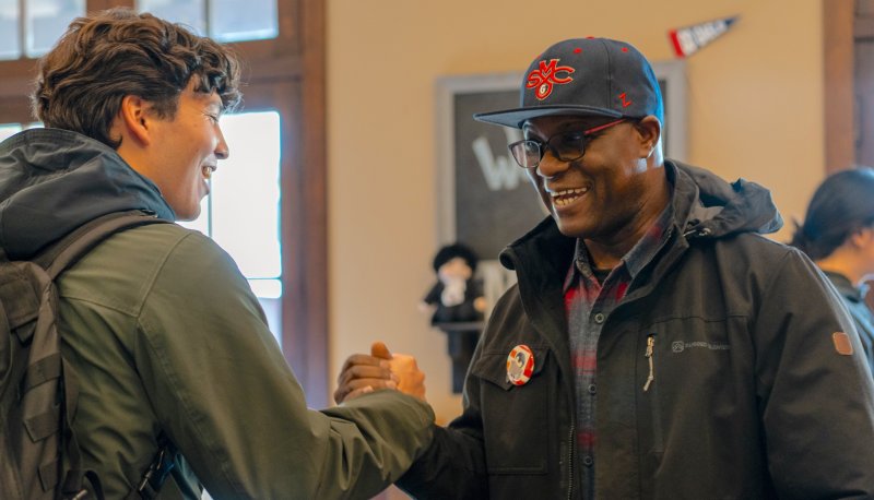 Father Kwame Assenyoh greeting a Saint Mary's student