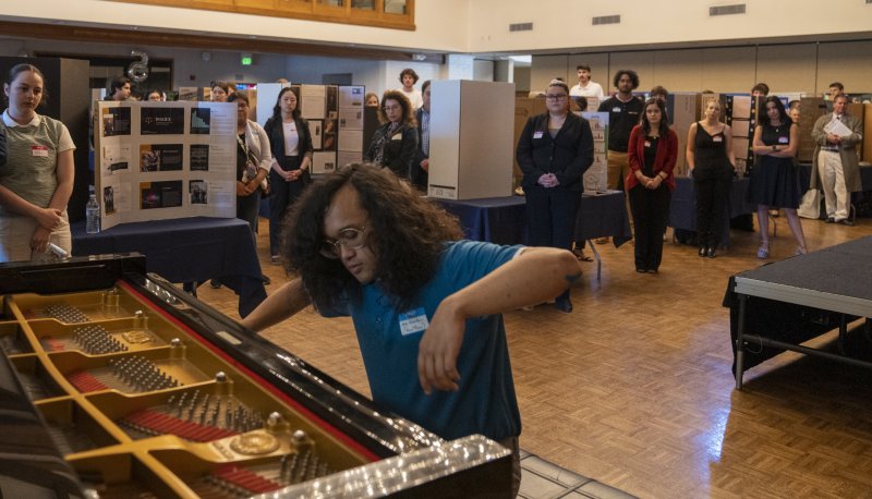 Aria Querubin '24 playing piano at 2023 SMC Student Research and Creative Works Conference