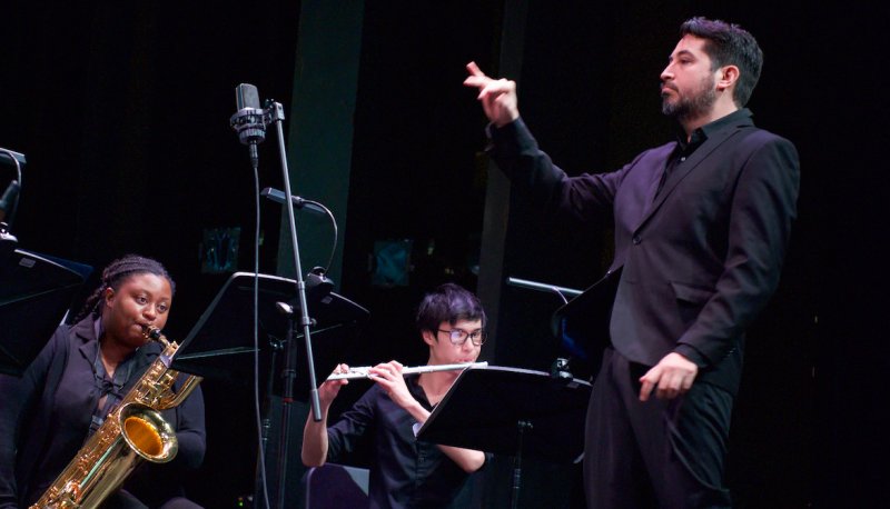 Dr. Sixto F. Montesinos conducting Makaiya Bedford and Michael Welsh with a black background
