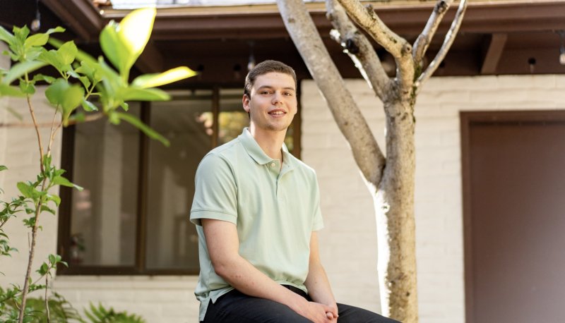 Andrew Aroutynov '24 posed outside SEBA building