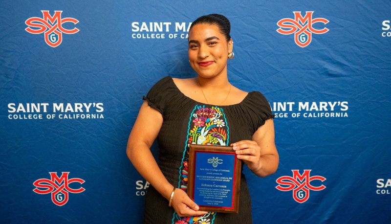 Rebecca Carranza posing with award