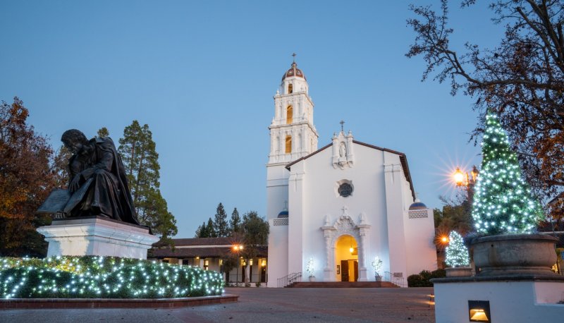Saint Mary's Chapel at dusk with a lit-up Christmas tree