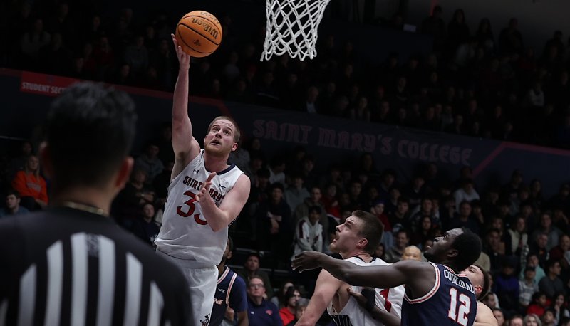 Men's basketball player Luke Barrett shoots against Pepperdine in January 2025