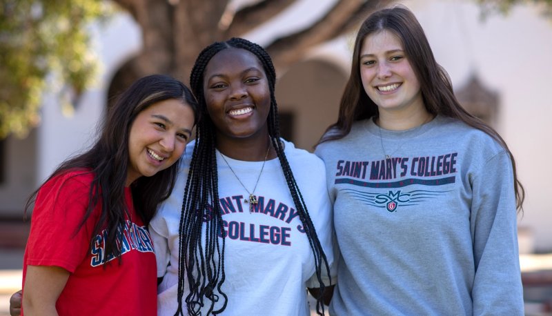 Three female students smiling, at WOWIE weekend 2024
