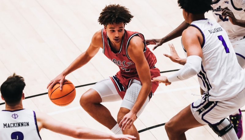 Men's basketball player Jordan Ross dribbles against Portland in January 2025