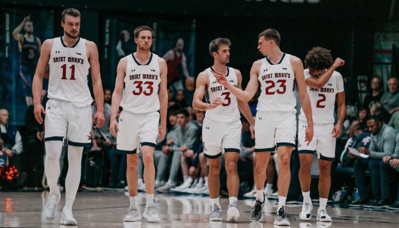 Five men's basketball players walk on the court against Gonzaga in February 2025
