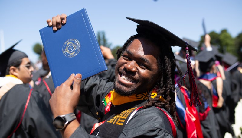 Student holding up diploma at Saint Mary's Undergraduate Commencement 2025