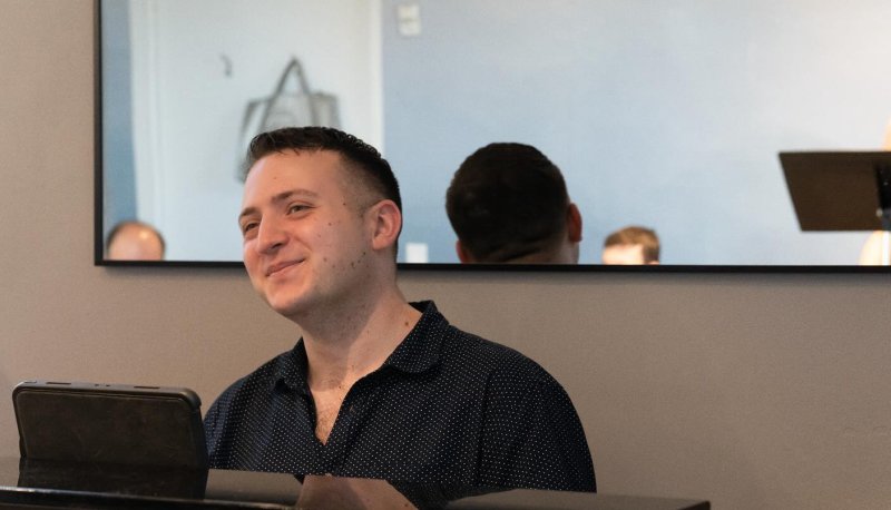 Nick Perez at a piano in a rehearsal space