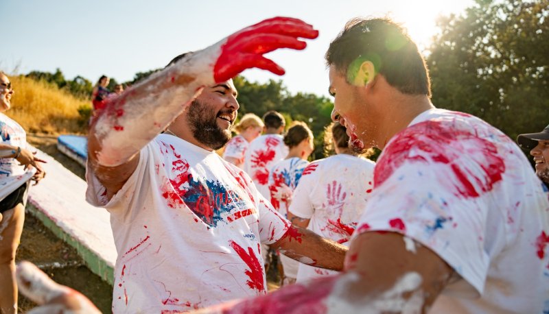 Two students embrace during Paint the SMC in 2024