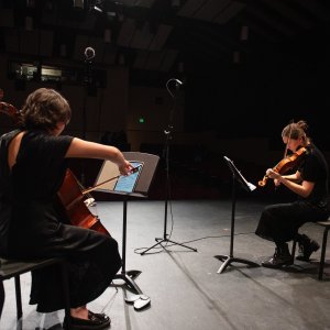 two musicians performing on stage at LeFevre theatre