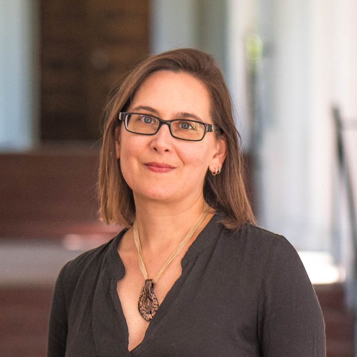 Deanna Zibello against a faded background of a Saint Mary's outdoor hallway