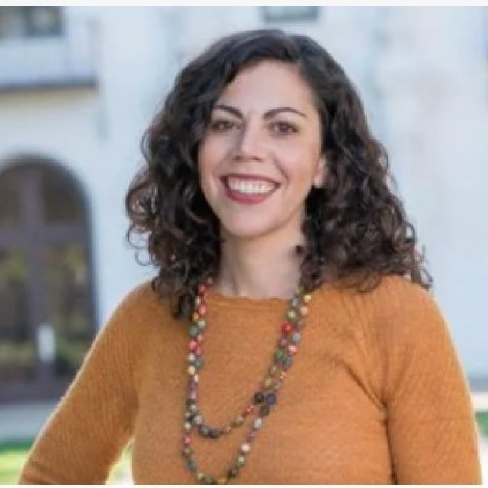 Headshot of Prof. Emily Klein in front of De La Salle Hall