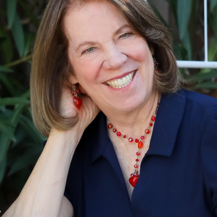 Headshot of Jenyth Gearhart-Utchen with plants in background