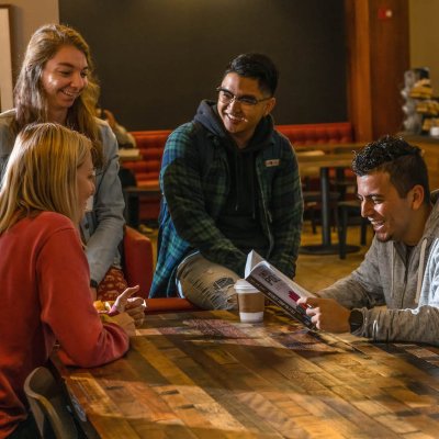 students at desk having fun