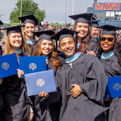 Graduate students hold their diplomas and celebrate at Saint Mary's 2023 Commencement