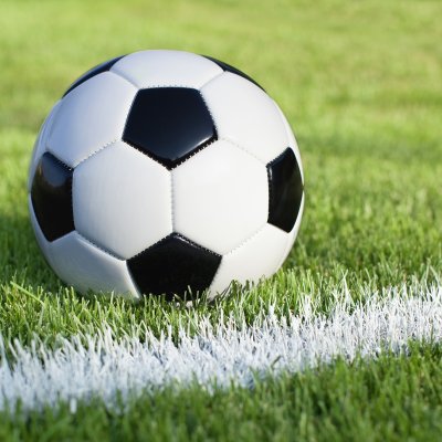 Soccer ball on field with stripe