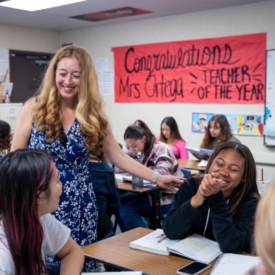Annalouisa Gonzalez-Ortega smiles while talking with students in her classroom