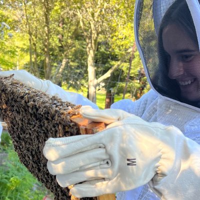 Female student Hathaway Scarping holding honeycomb