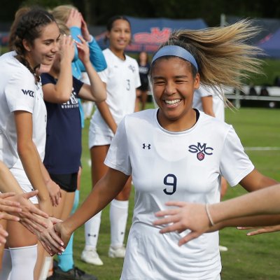 Women's Soccer player Makena Carr congratulated by teammates after victory over Portland in fall 2023