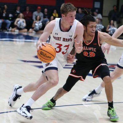 Men's basketball player Luke Barrett, No. 33, drives against Pacific while a defender tries to stop him, in January 2024