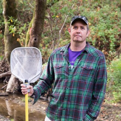 Michael Marchetti out in the field holding a net