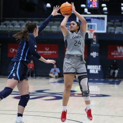 Women's basketball player Zeryhia Aokuso shoots against USD in January 2024