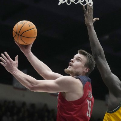 Men's basketball player Mitchell Saxen shoots against USF in February 2024