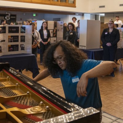 Aria Querubin '24 playing piano at 2023 SMC Student Research and Creative Works Conference