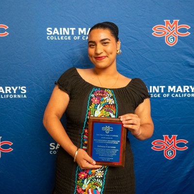 Rebecca Carranza posing with award