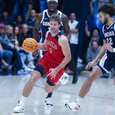 Augustas Marciulionis drives against Gonzaga, with 2 Gonzaga players and teammate Mitchell Saxen in the background