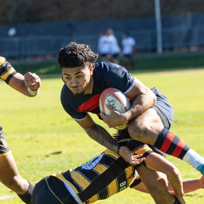 Iosefa Toia’ivao Runs through the defender during the Saint Mary's Rugby Match against Long Beach state.