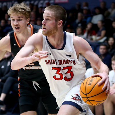 Men's Basketball player Lue Barrett drives against Pacific