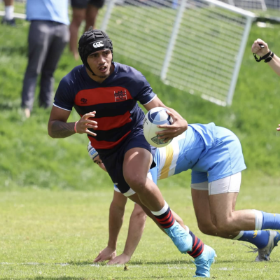 Men's Rugby Player Siale Ofa runs with the ball against UCLA in April 2025
