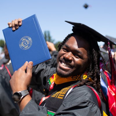 Student holding up diploma at Saint Mary's Undergraduate Commencement 2025