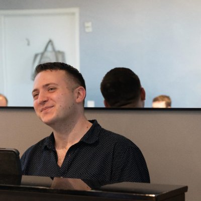 Nick Perez at a piano in a rehearsal space