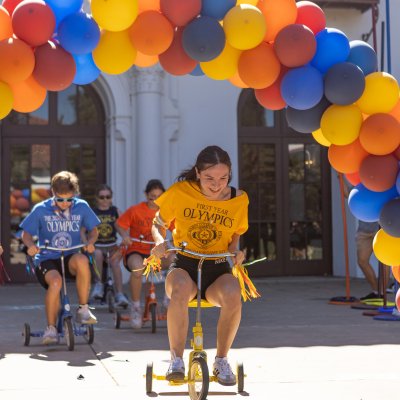 Paola Quintero ‘29, representing De La Salle hall in the lead during the tricycle race at the First Year olympic event on Sept 14, 2025. / Photo by Rebecca Harper