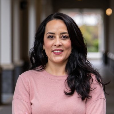 María Luisa Ruiz headshot with blue pattern background