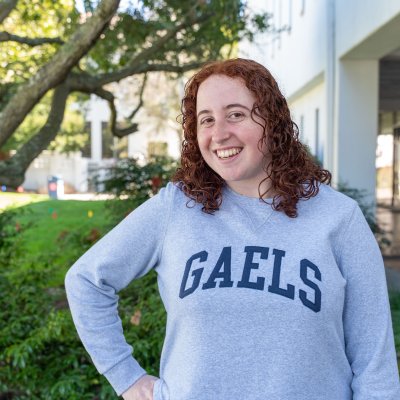 Carolyn Gersten smiles in front the of the library