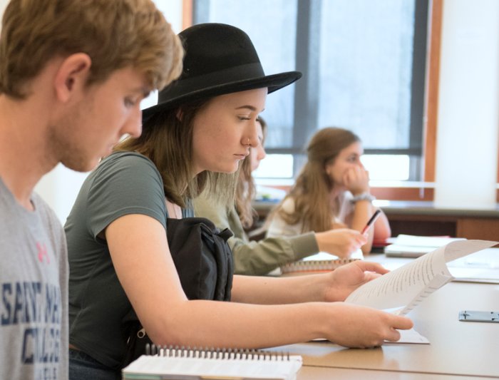 Students sitting in class looking at papers