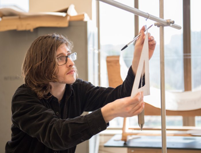 A student measuring an angle in class