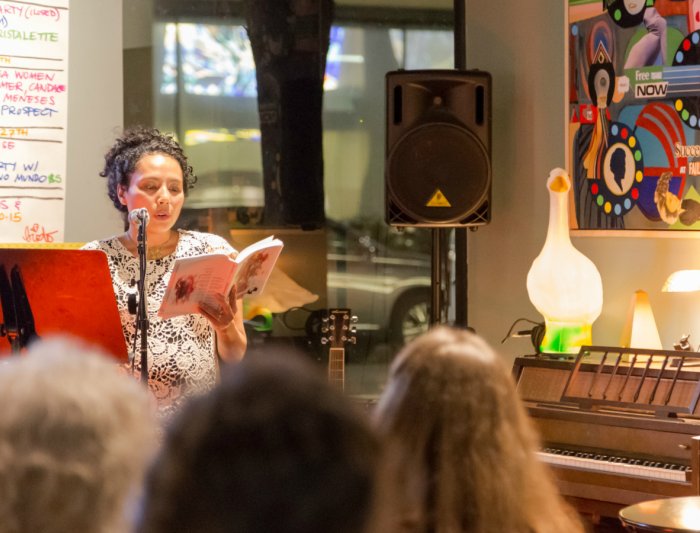 A writer performs her work for an audience