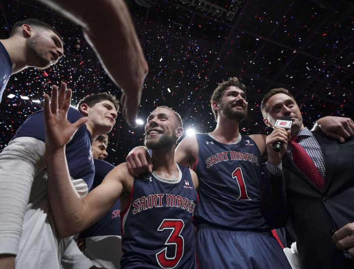 Jordan Ford and teammates high five at the WCC Championship