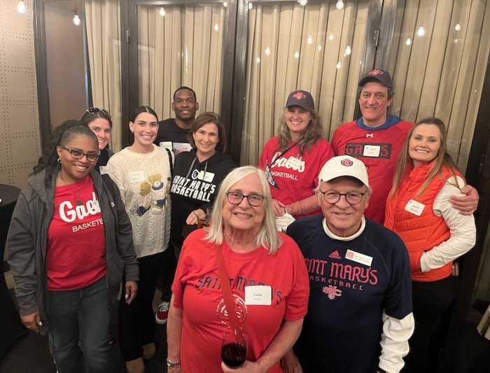 Ten people in SMC apparel smile at the camera